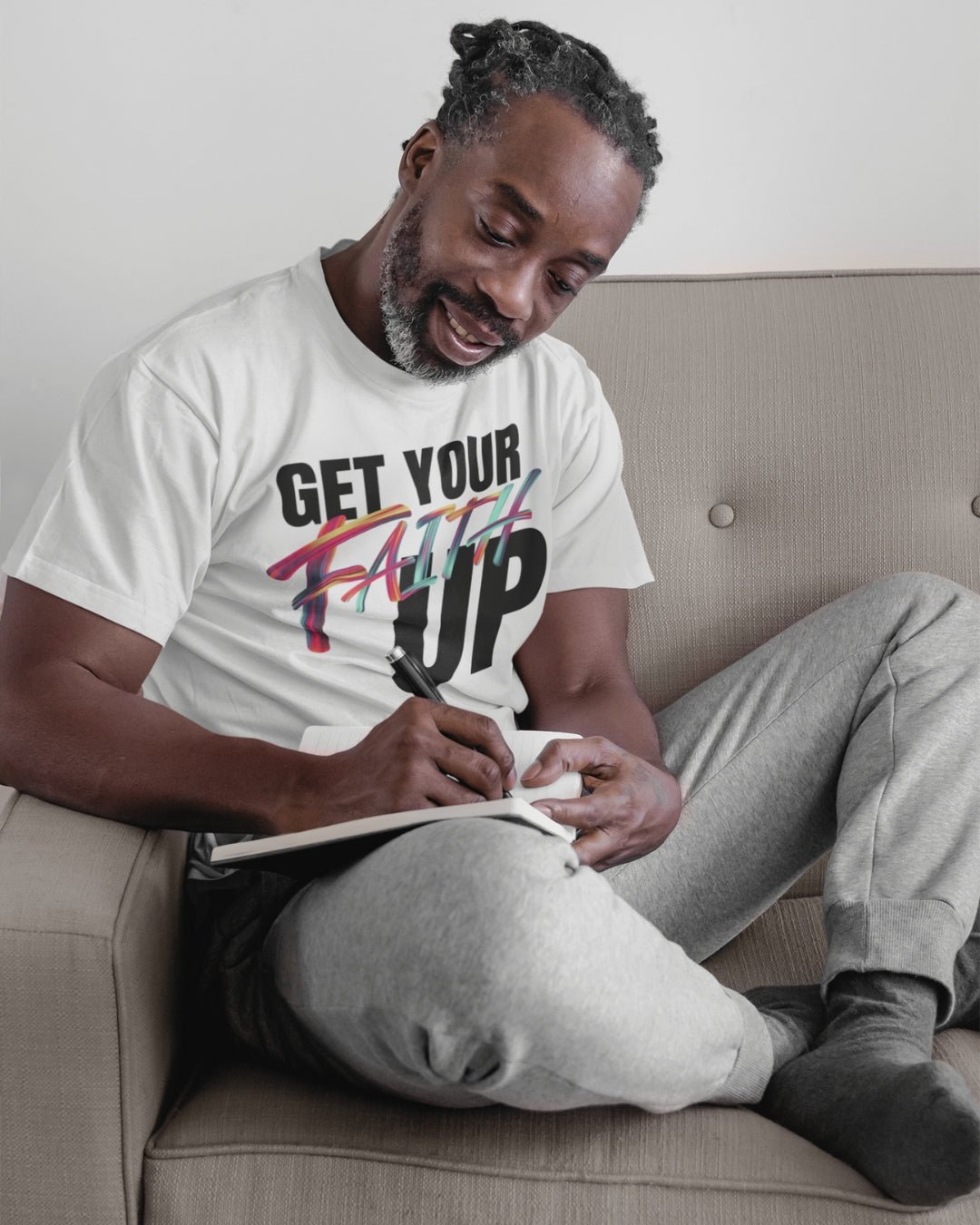 Get Your Faith Up - White - Black American Man - Sitting - Writing on the Journal