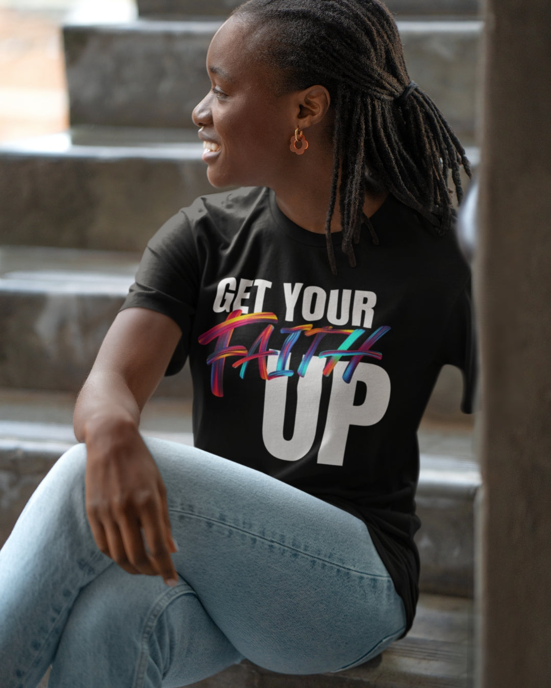 Get Your Faith Up - African American Woman - Black Shirt - Faded Jeans - Sitting on stairs - Smiling